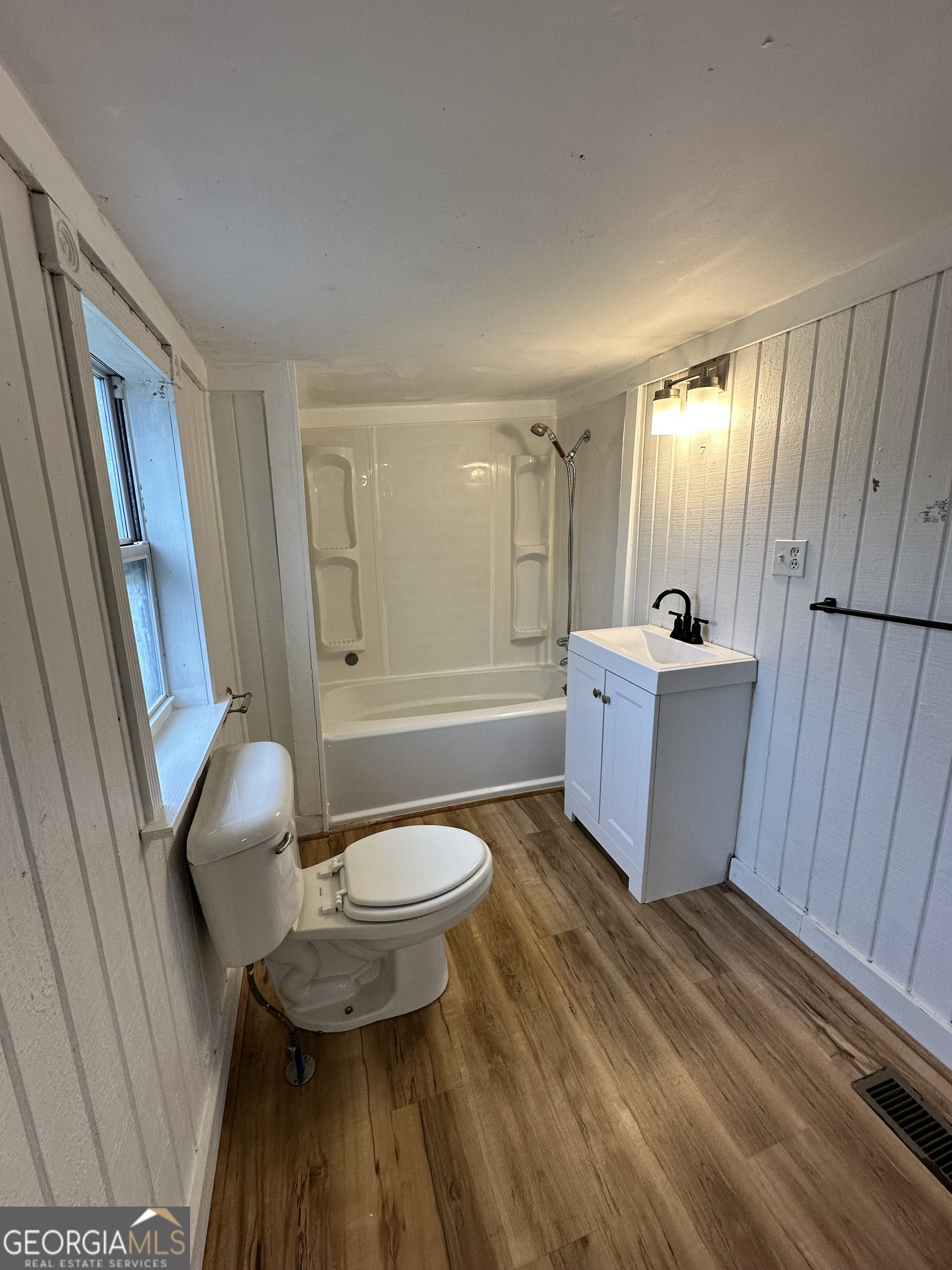 55 Bowdon Street Waco, GA 30182 - Photo 17 of 18 a bathroom with a sink toilet a mirror and vanity