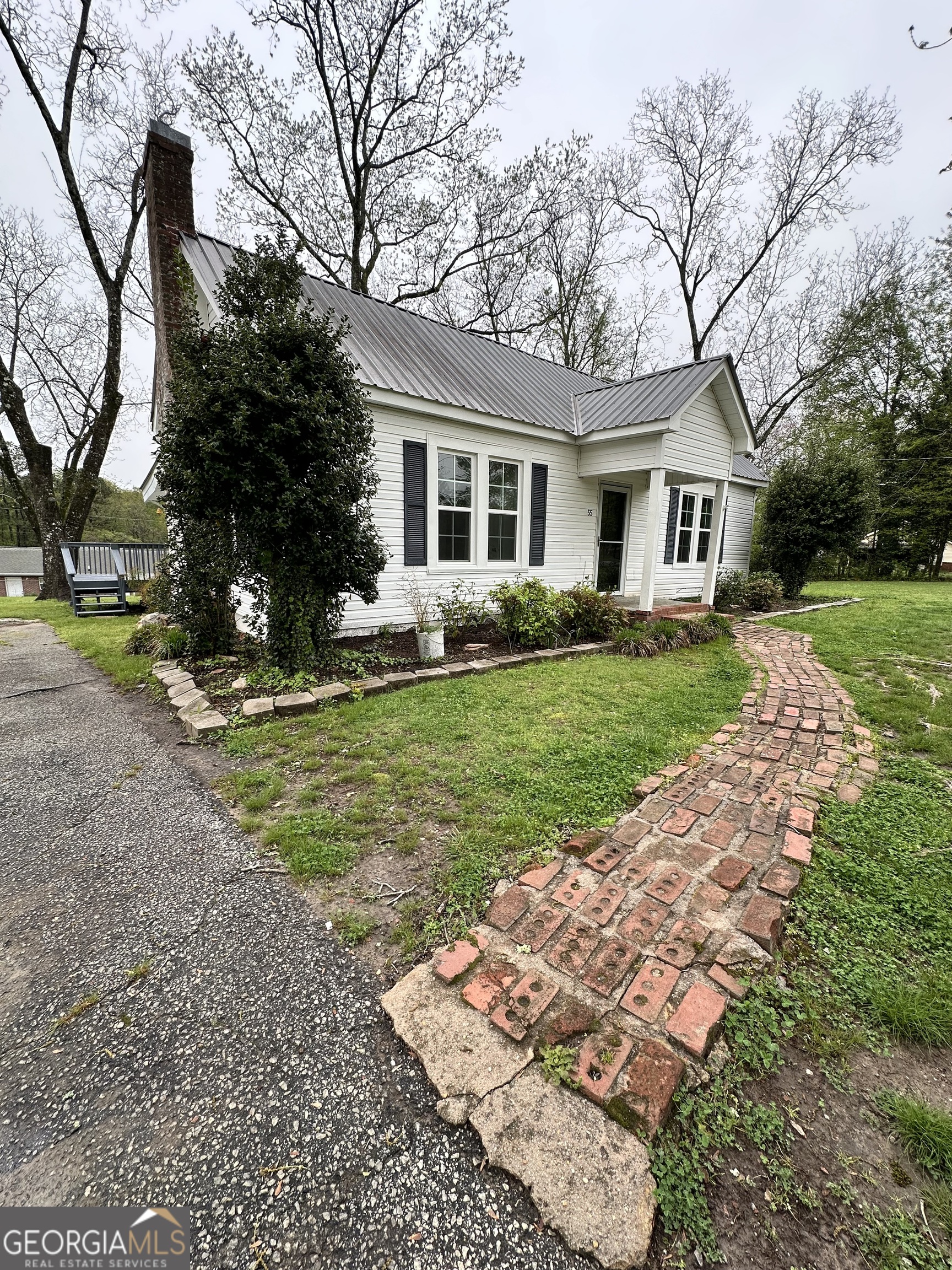 55 Bowdon Street Waco, GA 30182 - Photo 3 of 18 a front view of a house with garden