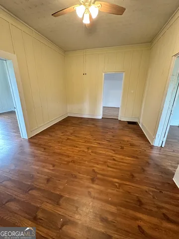 a view of an empty room and wooden floor