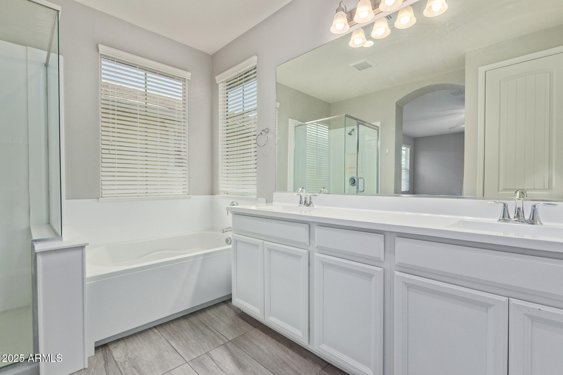 3934 East Turley Street Gilbert, AZ 85295 - Photo 15 of 37 a bathroom with a bathtub a sink and a window