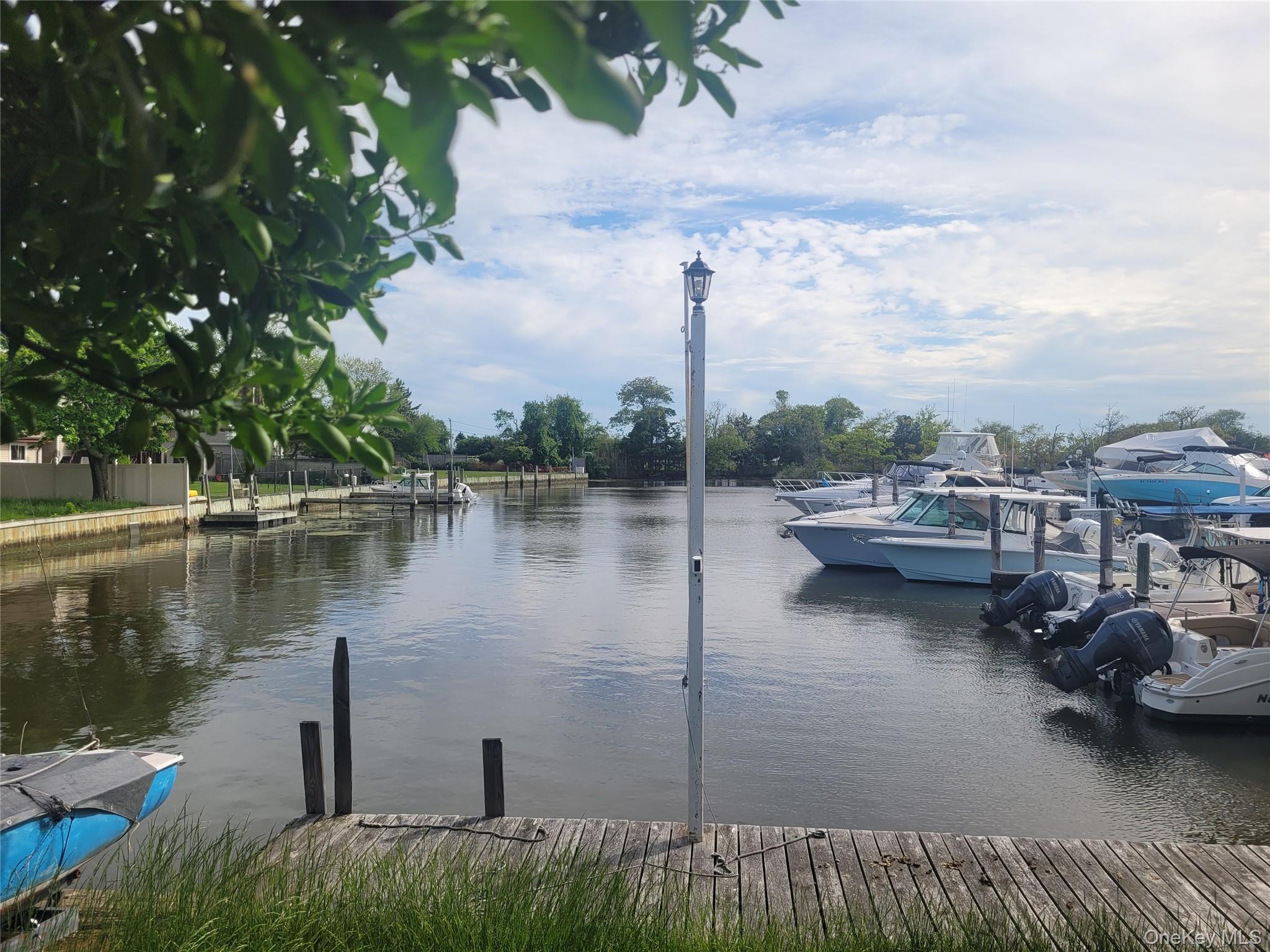 8 Cornell Road East Patchogue, NY 11772 - Photo 3 of 18 a view of a lake with cars parked