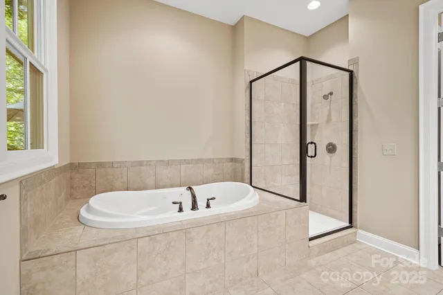 a bathroom with a tub and a shower