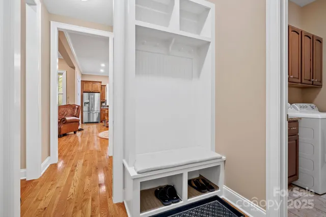 a view of a livingroom with wooden floor and a fireplace