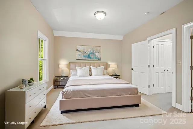 a bedroom with a bed and a painting on the wall