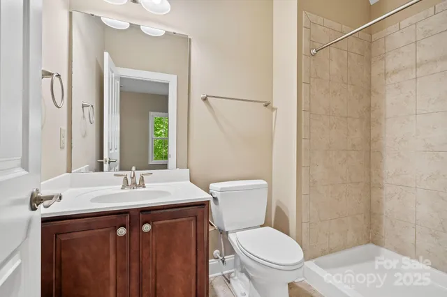 a bathroom with a sink vanity mirror and toilet