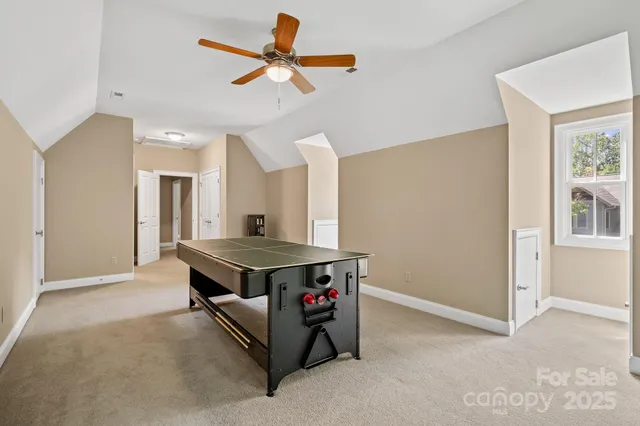 a room with pool table and a ceiling fan