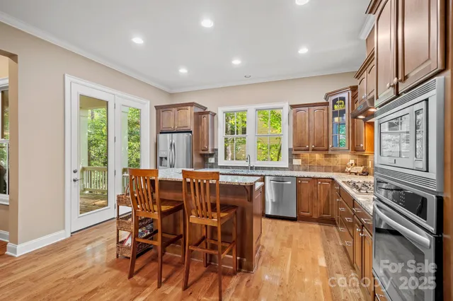 a kitchen with stainless steel appliances granite countertop a stove top oven a sink with granite countertops and cabinets