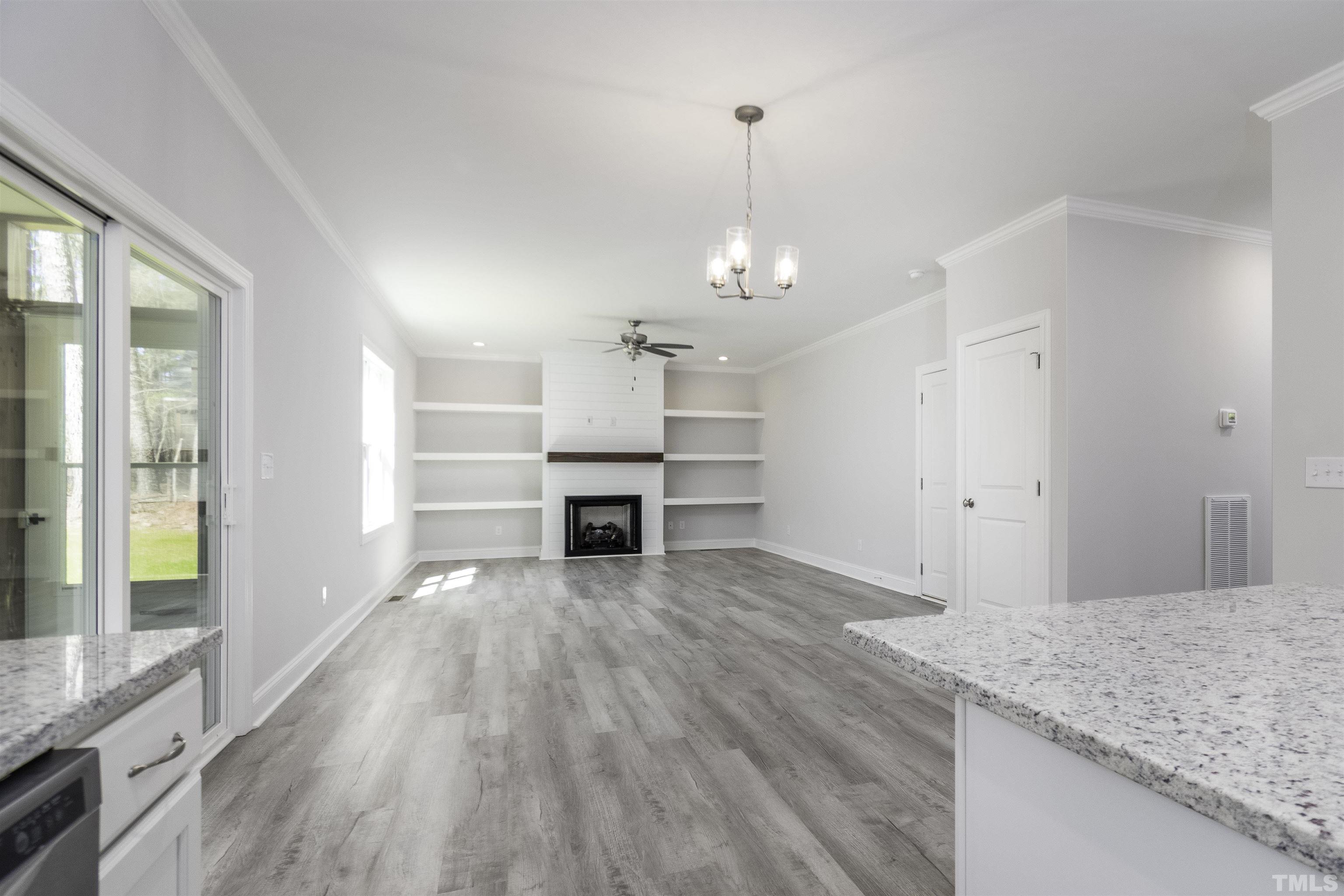 2758 Sledge Road Louisburg, NC 27549 - Photo 11 of 38 a view of kitchen and hall with wooden floor
