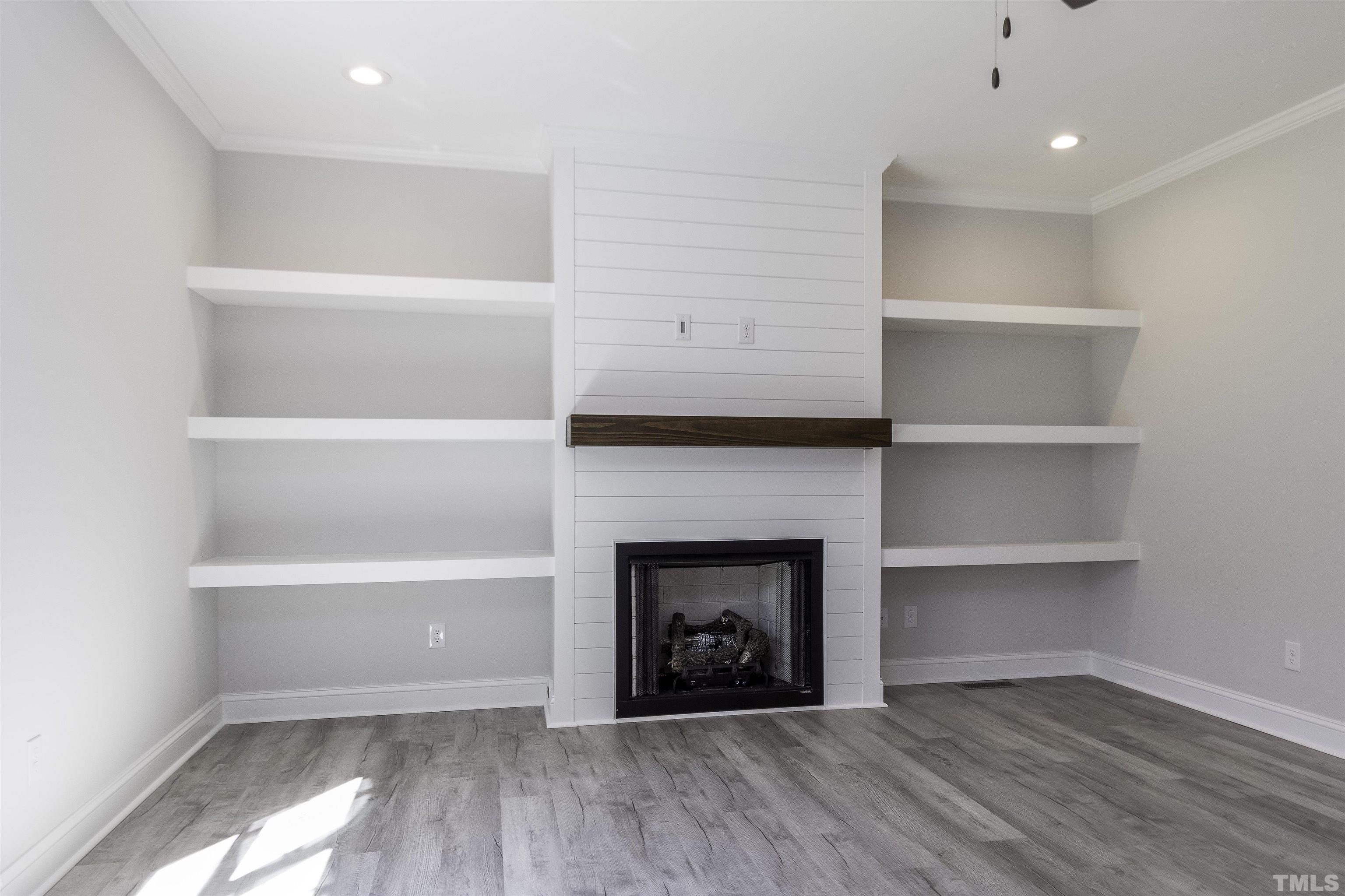 2758 Sledge Road Louisburg, NC 27549 - Photo 12 of 38 a view of an empty room with a fireplace and a window