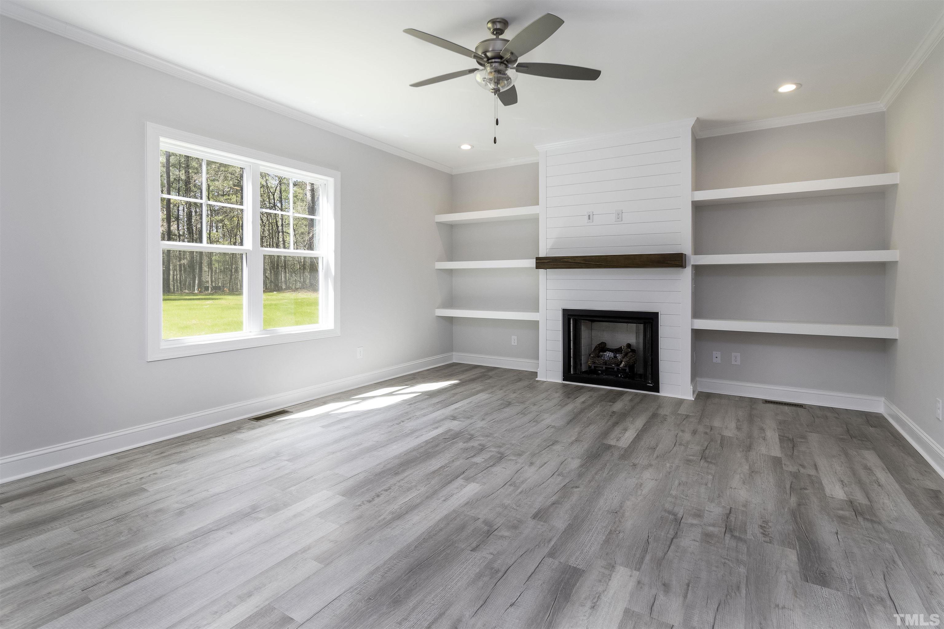 2758 Sledge Road Louisburg, NC 27549 - Photo 13 of 38 a view of an empty room with a window and fireplace