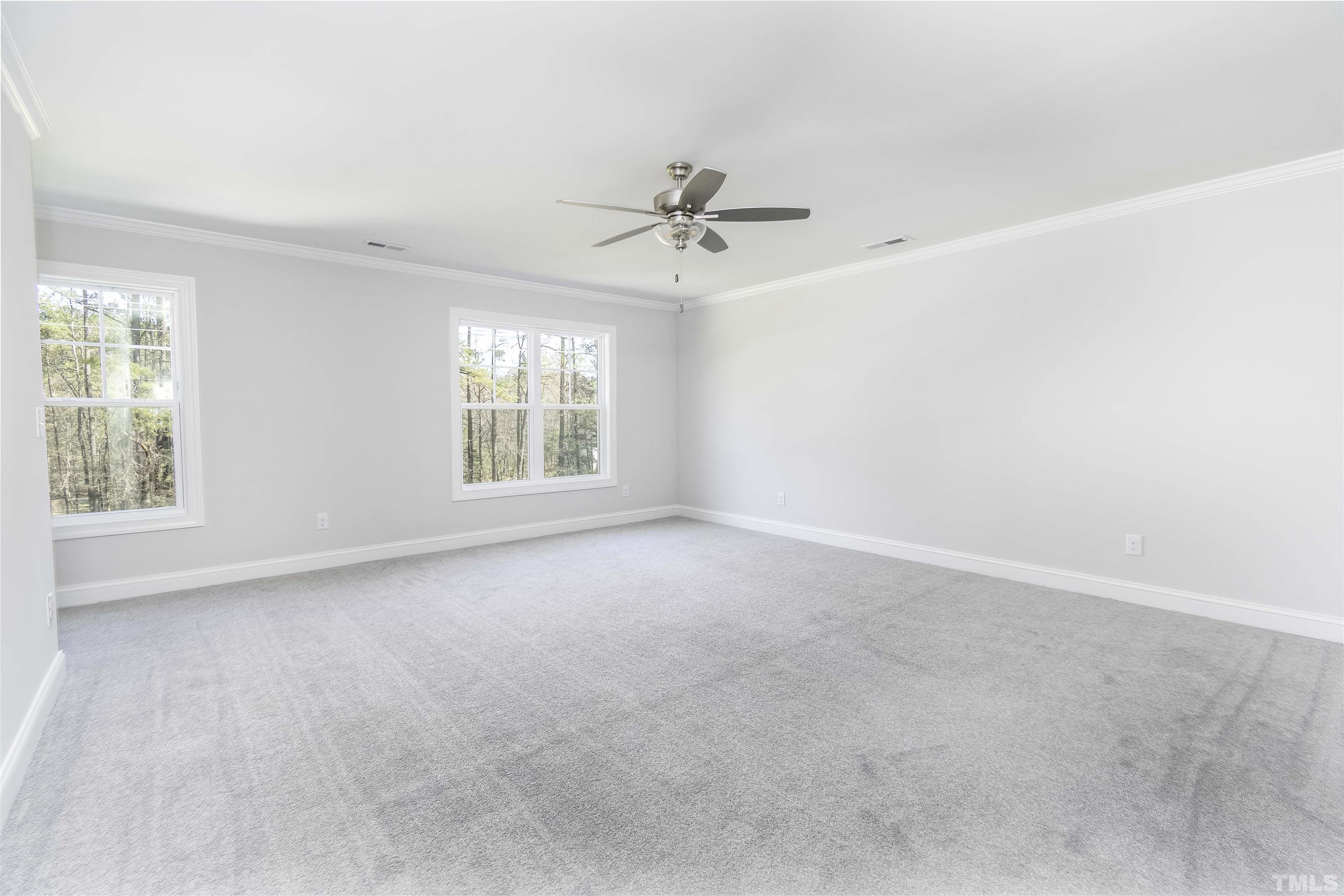 2758 Sledge Road Louisburg, NC 27549 - Photo 16 of 38 an empty room with windows and ceiling fan view