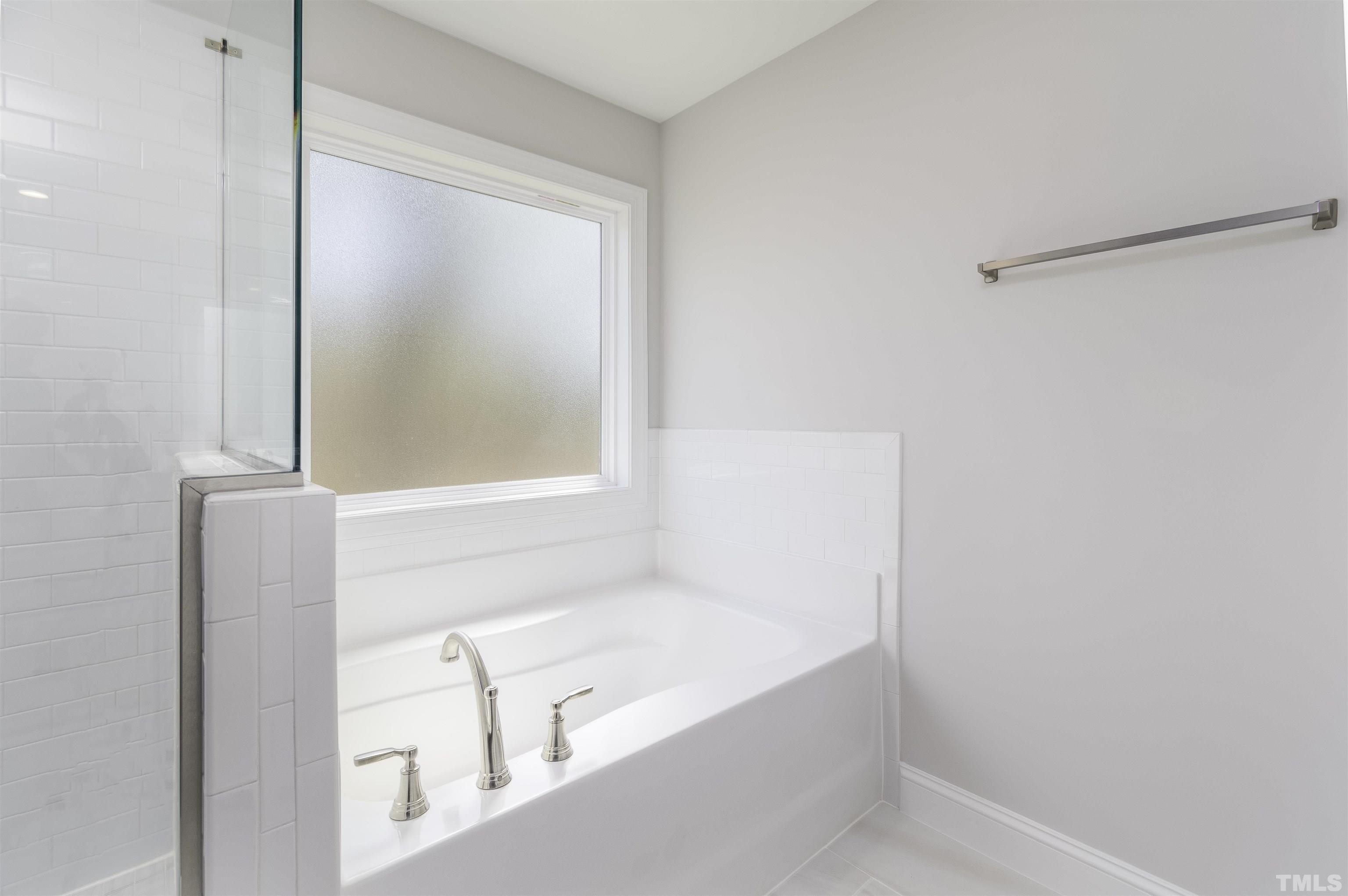 2758 Sledge Road Louisburg, NC 27549 - Photo 19 of 38 a bathroom with a bathtub and a shower
