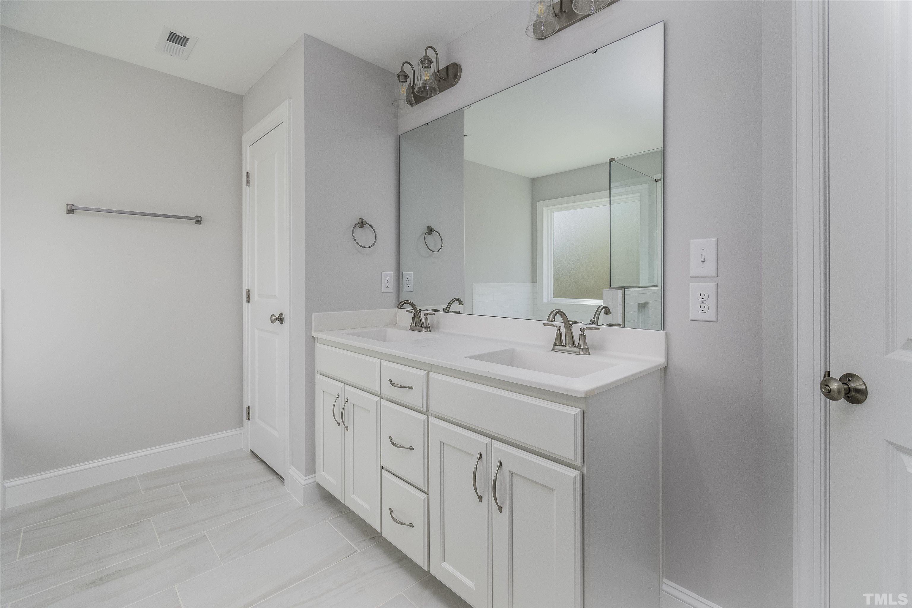 2758 Sledge Road Louisburg, NC 27549 - Photo 21 of 38 a bathroom with a sink a mirror and a shower