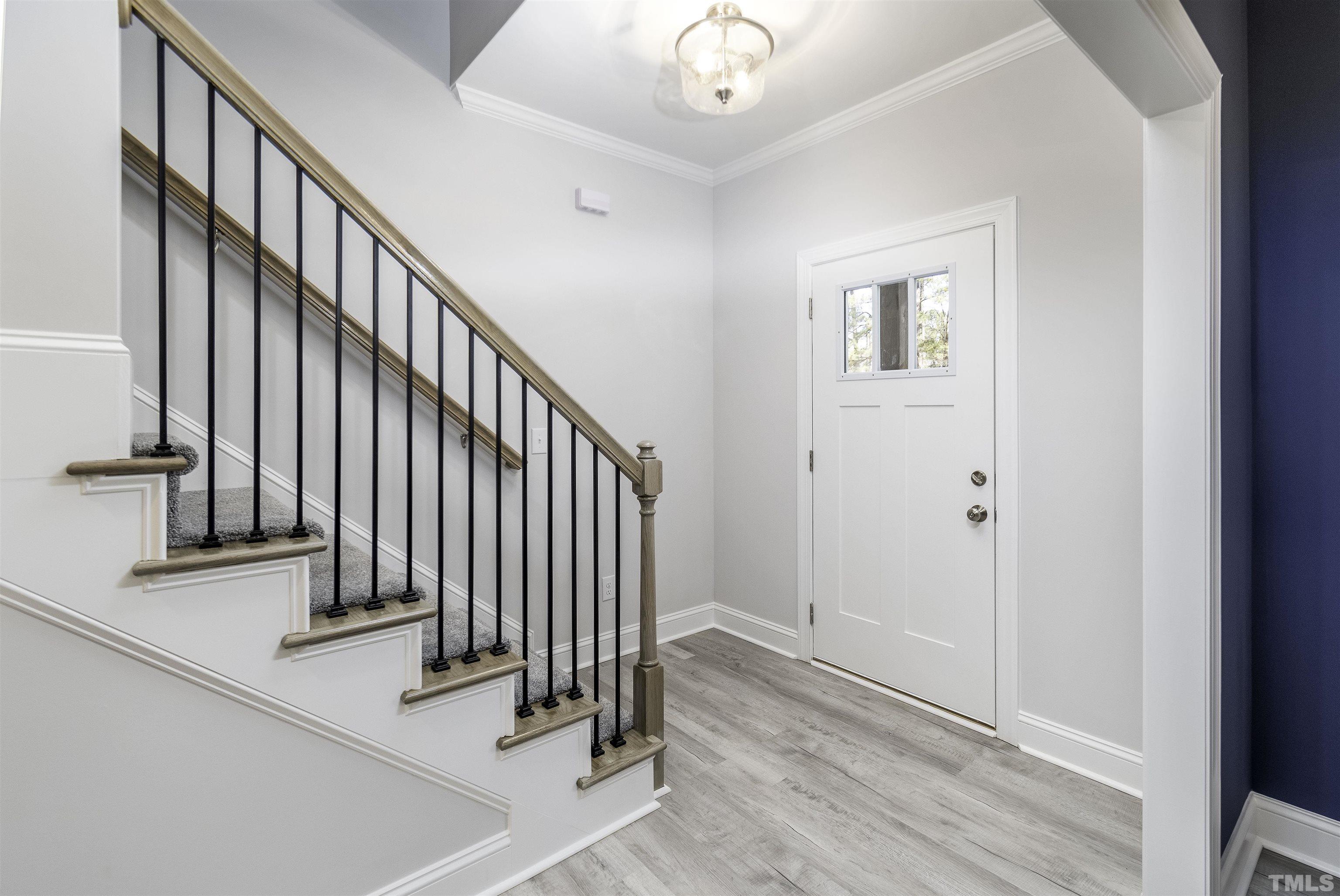 2758 Sledge Road Louisburg, NC 27549 - Photo 4 of 38 a view of a hallway with wooden floor and staircase