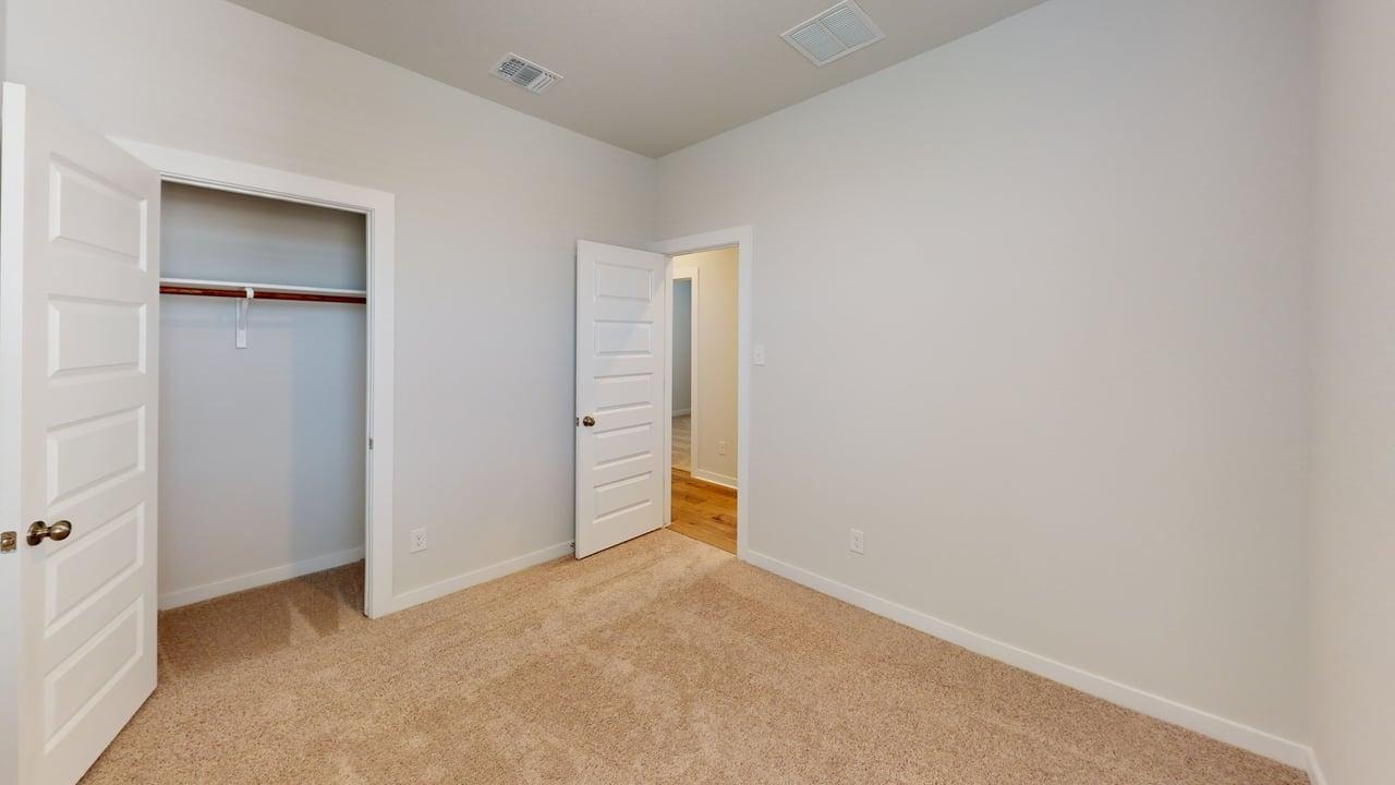 201 Firefox Way Jarrell, TX 76537 - Photo 15 of 27 Unfurnished bedroom featuring light colored carpet and a closet