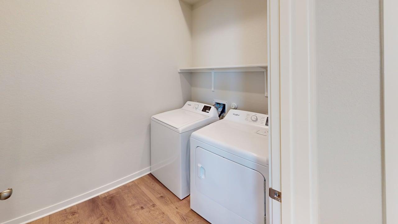 201 Firefox Way Jarrell, TX 76537 - Photo 20 of 27 Laundry area featuring light wood-type flooring and washer and clothes dryer