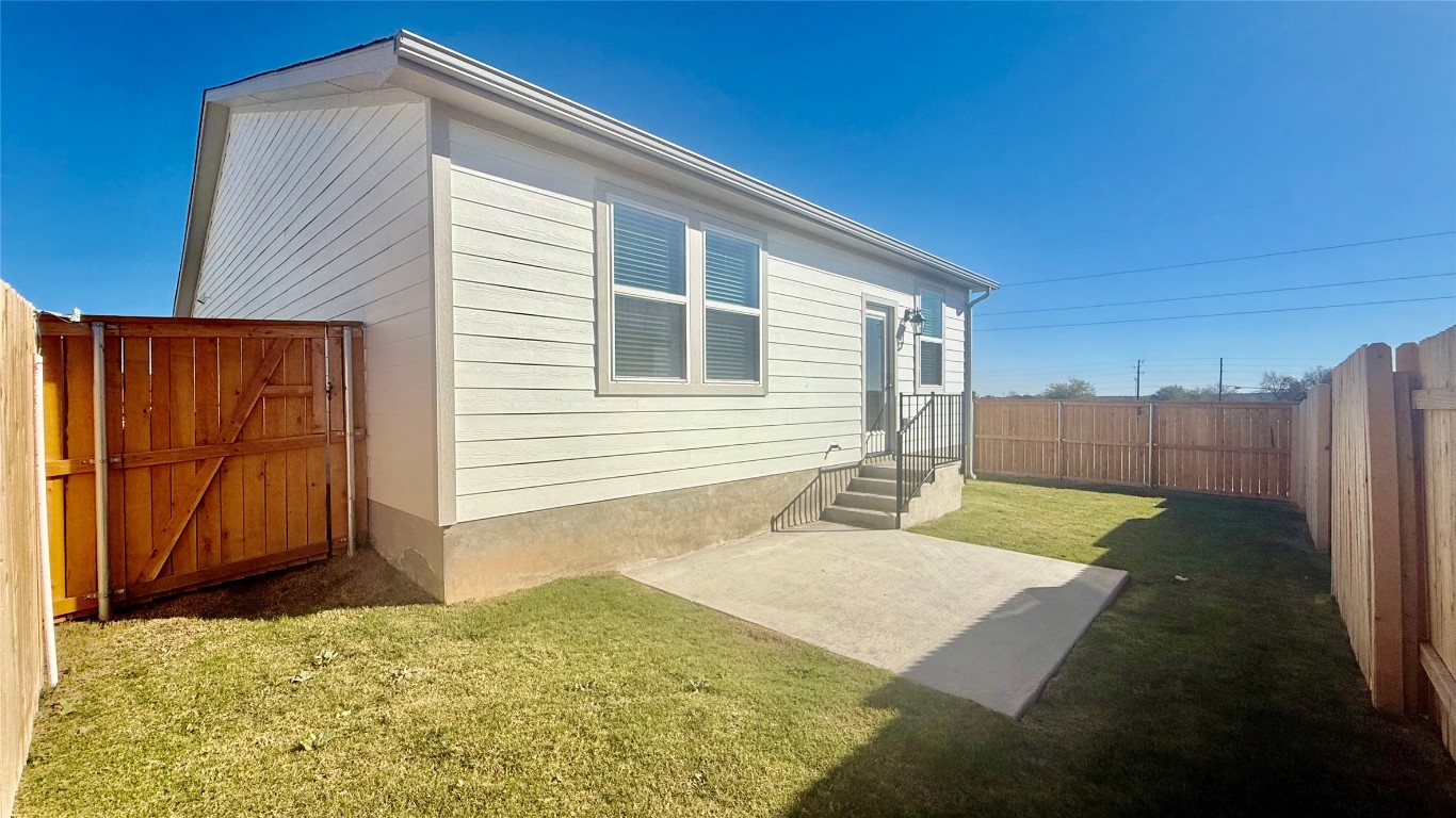 201 Firefox Way Jarrell, TX 76537 - Photo 22 of 27 Rear view of property featuring a fenced backyard, a patio area, and a gate