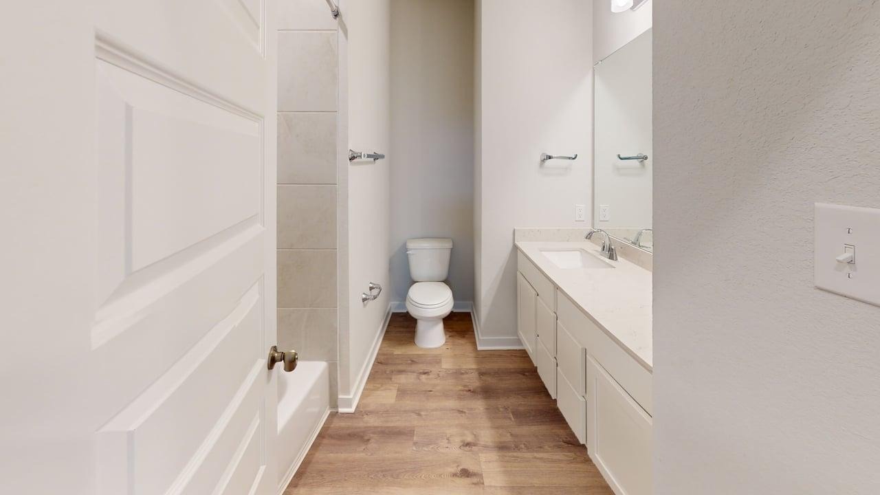 201 Firefox Way Jarrell, TX 76537 - Photo 8 of 27 Bathroom featuring vanity, light wood finished floors, and a bathtub