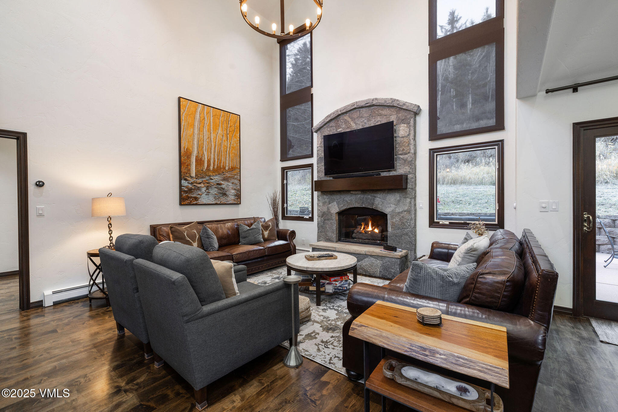 a living room with furniture a flat screen tv and a fireplace