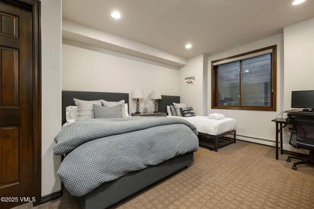 a bedroom with bed and a flat screen tv