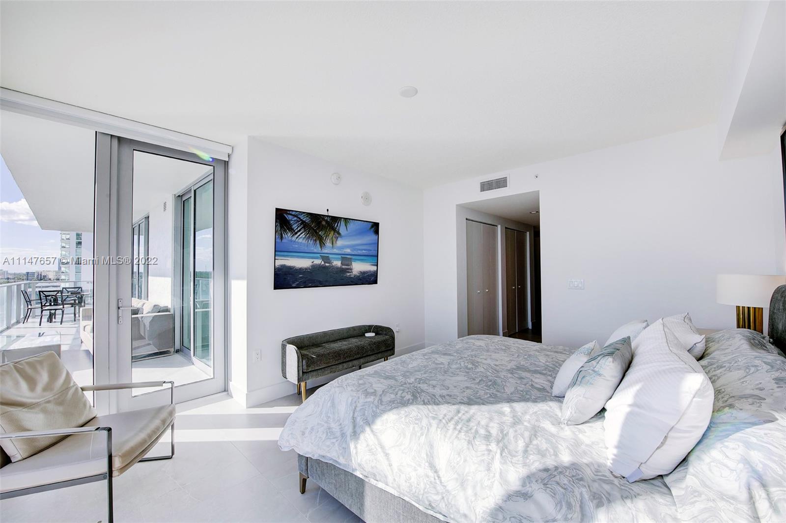 330 Sunny Isles Boulevard, Unit 5802 Sunny Isles Beach, FL 33160 - Photo 14 of 34 a bedroom with a bed and a tv