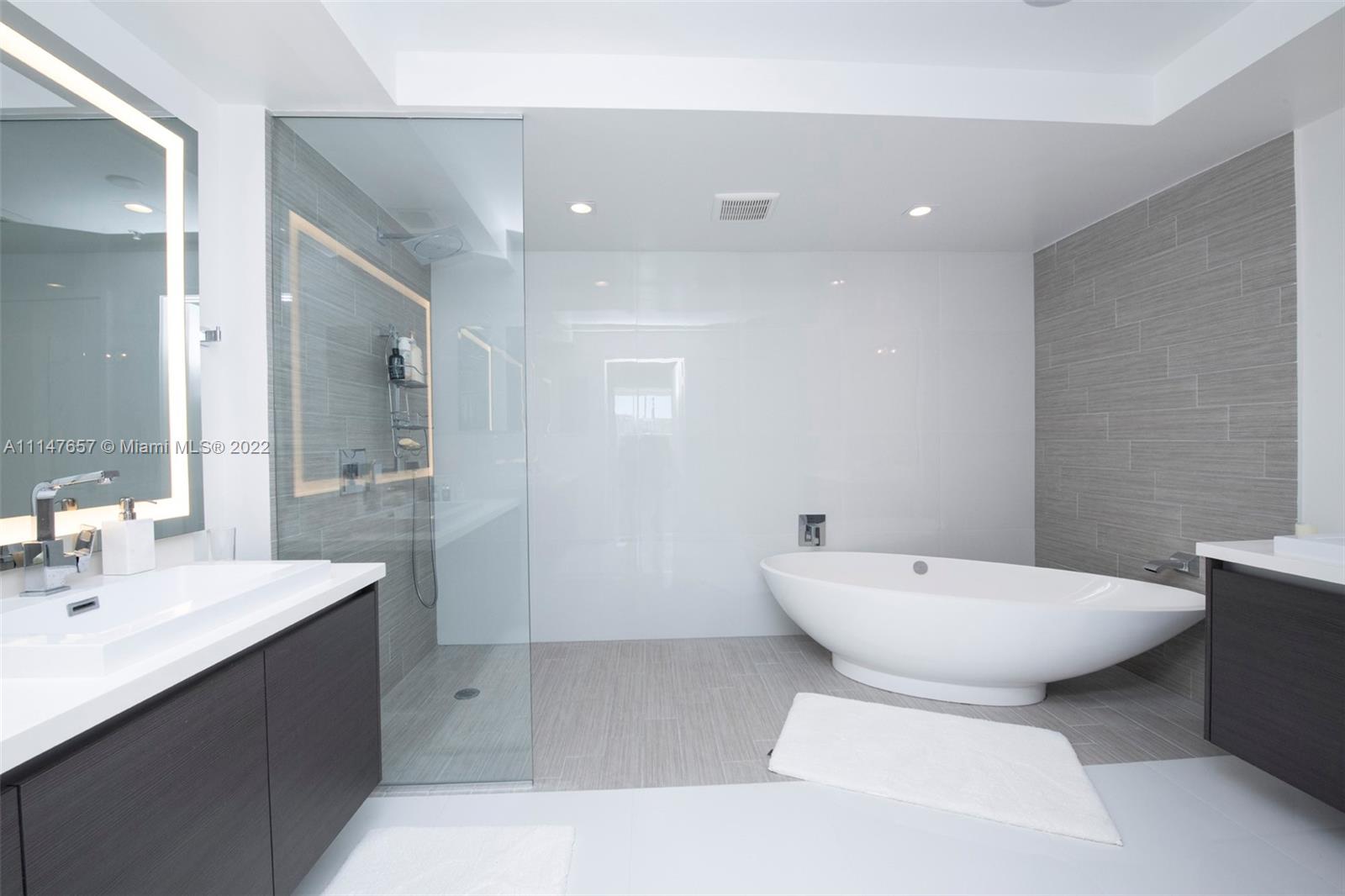 330 Sunny Isles Boulevard, Unit 5802 Sunny Isles Beach, FL 33160 - Photo 15 of 34 a bathroom with a sink toilet and shower