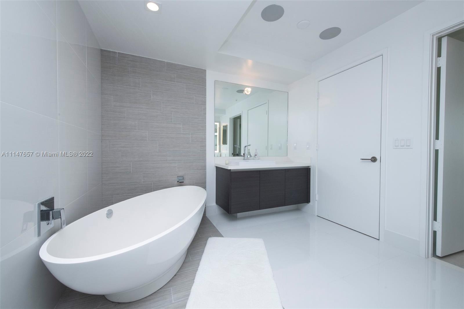 330 Sunny Isles Boulevard, Unit 5802 Sunny Isles Beach, FL 33160 - Photo 16 of 34 a bathroom with a tub and a sink