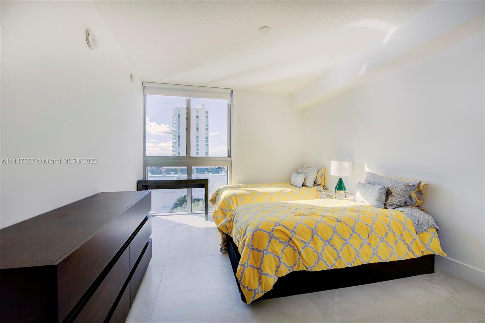 330 Sunny Isles Boulevard, Unit 5802 Sunny Isles Beach, FL 33160 - Photo 21 of 34 a bedroom with a bed and window