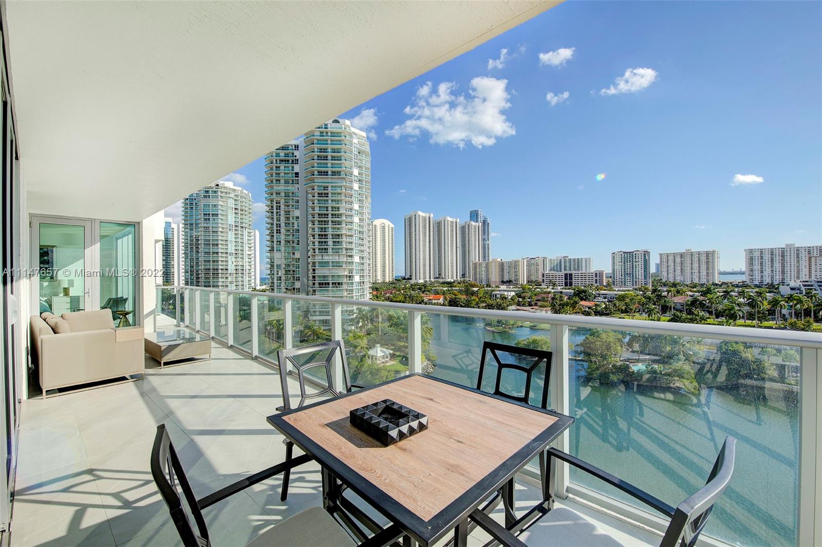330 Sunny Isles Boulevard, Unit 5802 Sunny Isles Beach, FL 33160 - Photo 25 of 34 a living room with furniture a rug and a floor to ceiling window