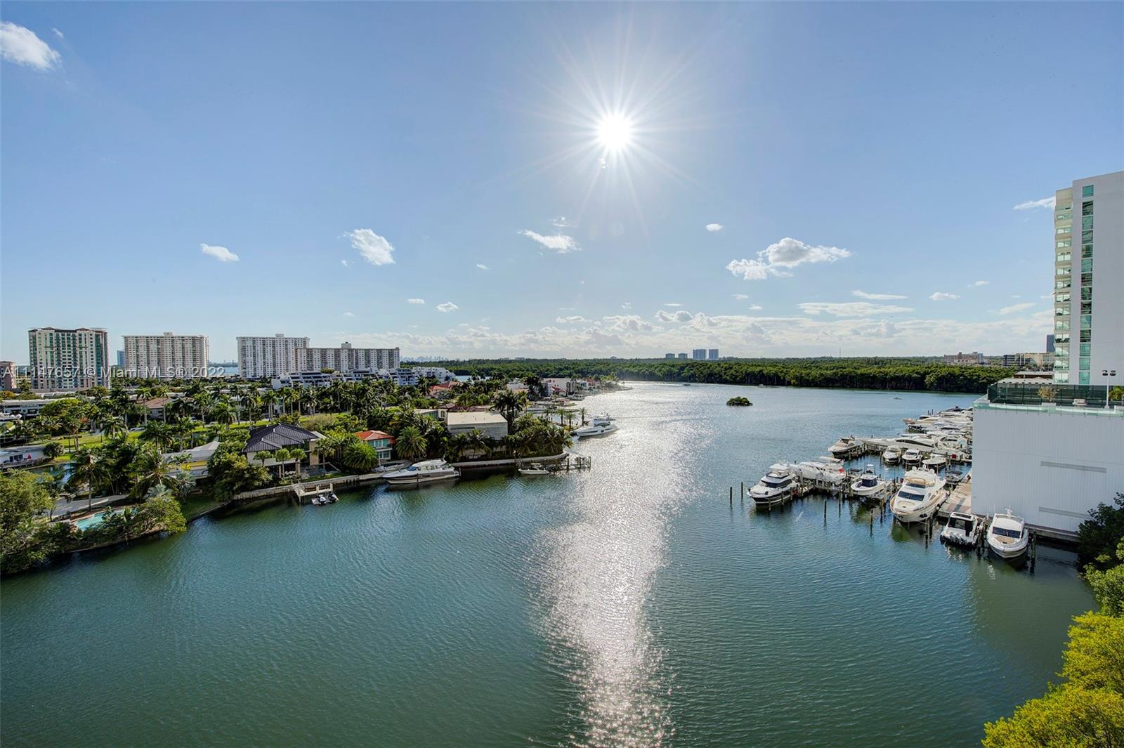 330 Sunny Isles Boulevard, Unit 5802 Sunny Isles Beach, FL 33160 - Photo 26 of 34 a view of a lake with boats and trees in the background