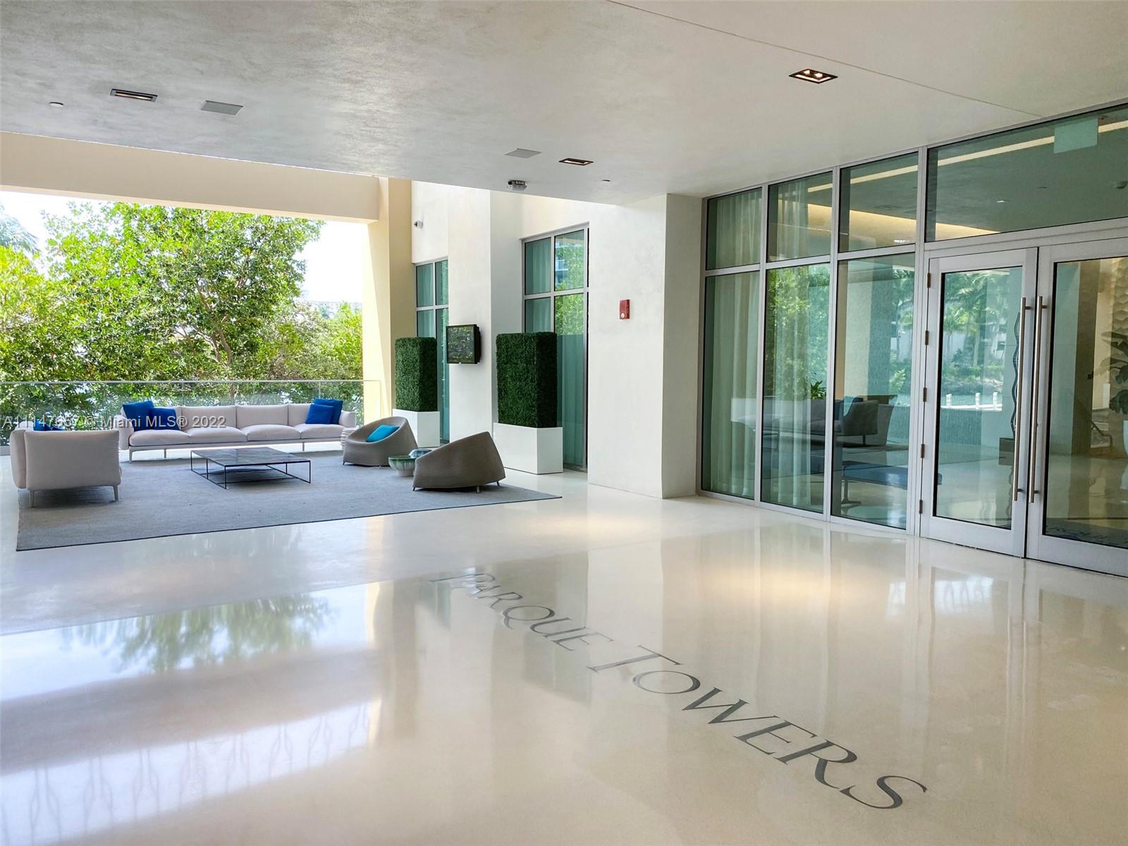 330 Sunny Isles Boulevard, Unit 5802 Sunny Isles Beach, FL 33160 - Photo 27 of 34 a living room with furniture and large windows