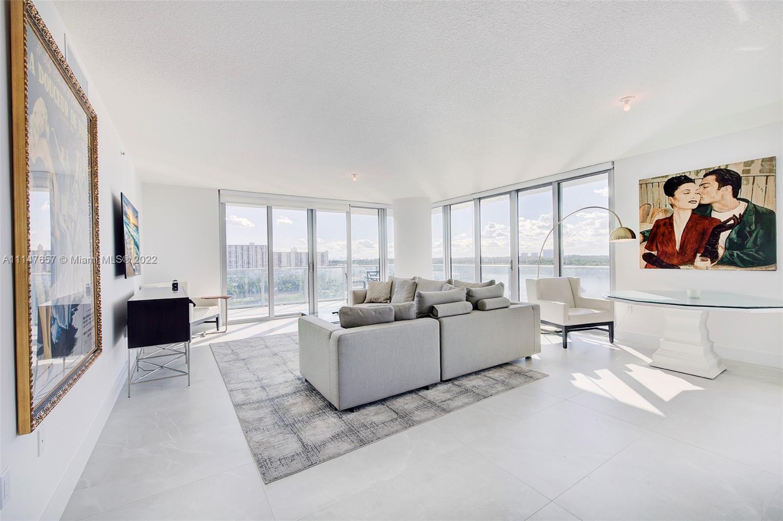 330 Sunny Isles Boulevard, Unit 5802 Sunny Isles Beach, FL 33160 - Photo 3 of 34 a living room with furniture and a floor to ceiling window