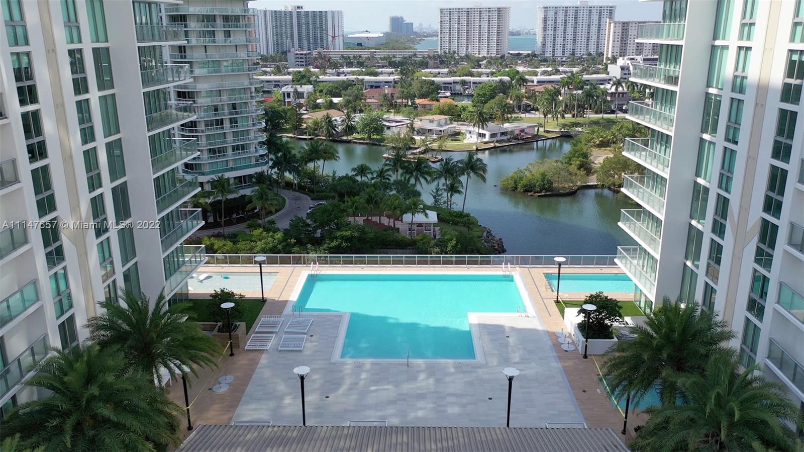 330 Sunny Isles Boulevard, Unit 5802 Sunny Isles Beach, FL 33160 - Photo 33 of 34 a view of swimming pool outdoor seating and lake view