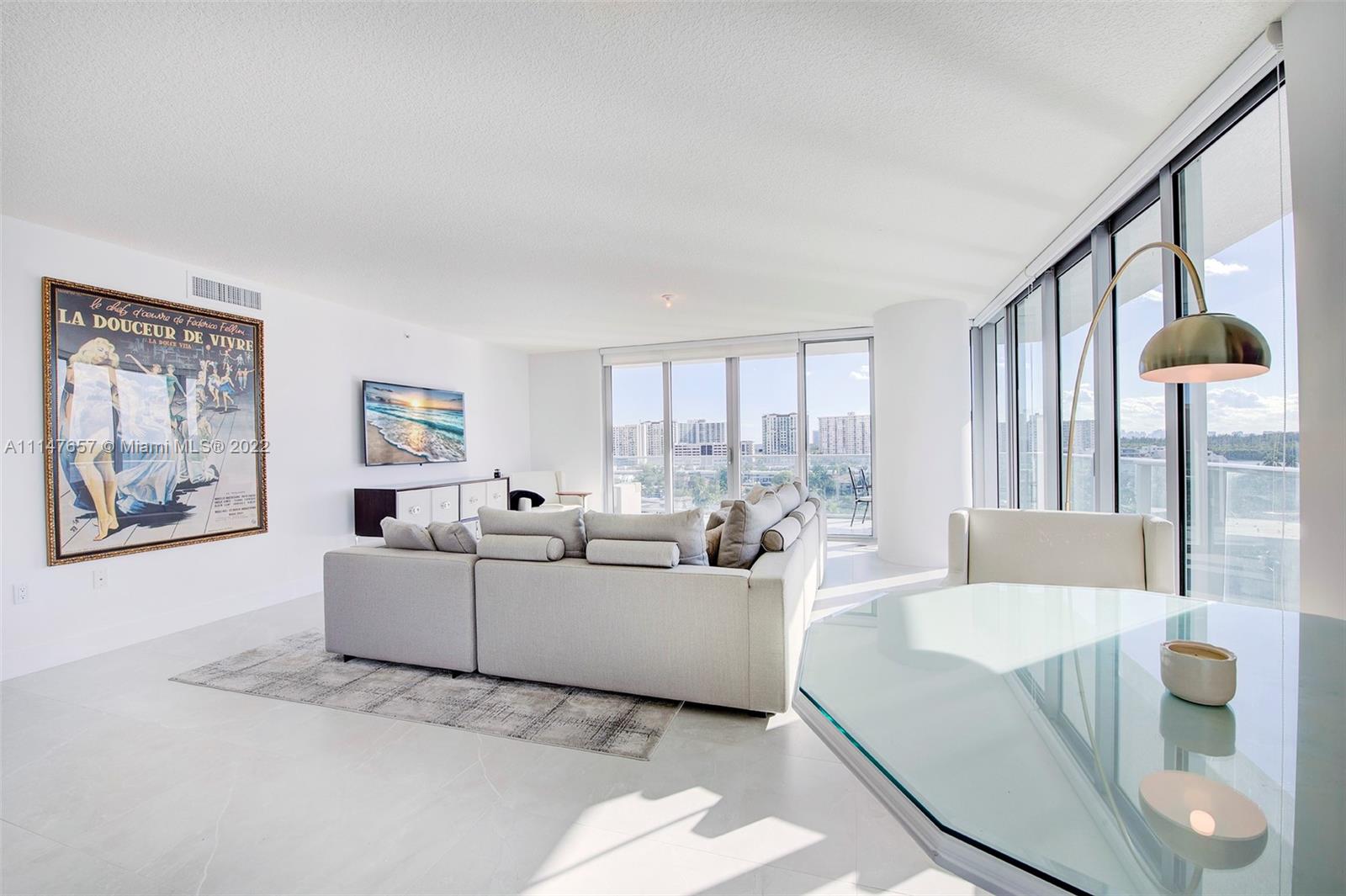 330 Sunny Isles Boulevard, Unit 5802 Sunny Isles Beach, FL 33160 - Photo 4 of 34 a living room with furniture and a large window