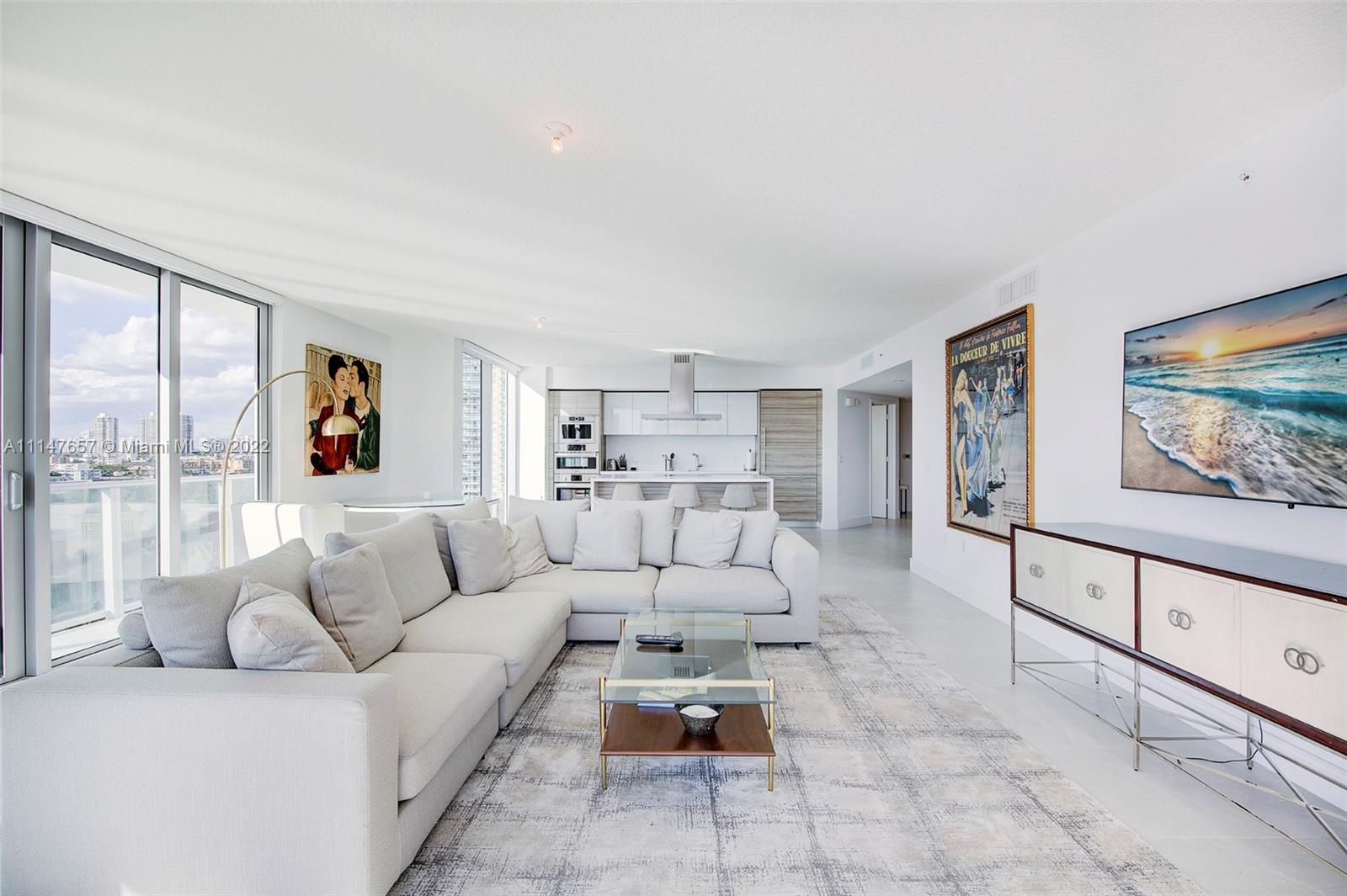 330 Sunny Isles Boulevard, Unit 5802 Sunny Isles Beach, FL 33160 - Photo 6 of 34 a living room with furniture and a painting on the wall