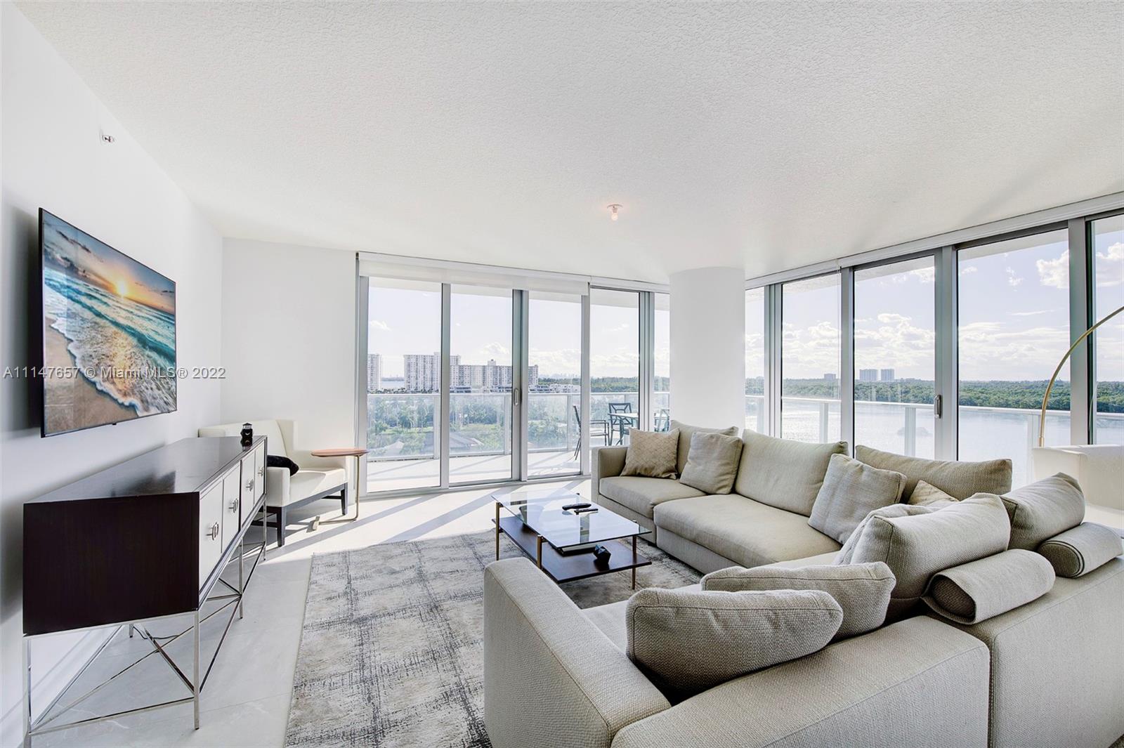 330 Sunny Isles Boulevard, Unit 5802 Sunny Isles Beach, FL 33160 - Photo 7 of 34 a living room with furniture and a large window