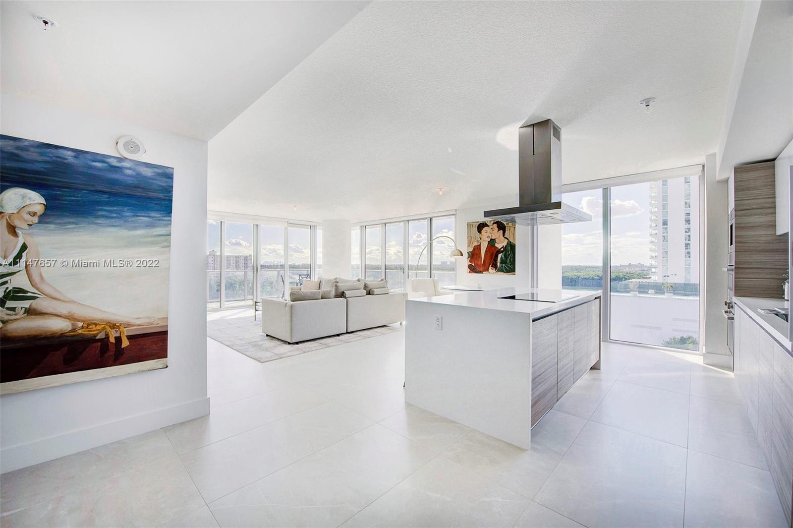 330 Sunny Isles Boulevard, Unit 5802 Sunny Isles Beach, FL 33160 - Photo 9 of 34 a living room with furniture and a flat screen tv
