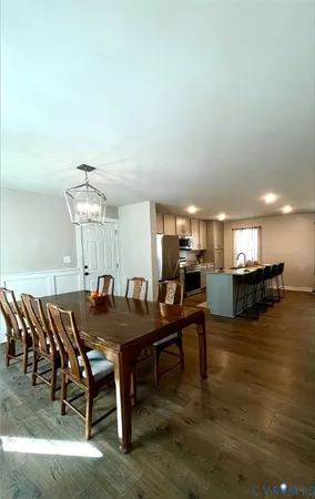 a kitchen with kitchen island granite countertop a sink stove and refrigerator