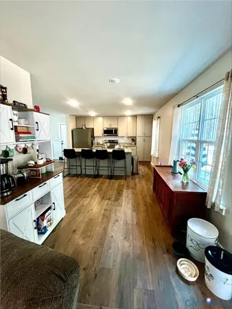 a view of hallway with livingroom and furniture