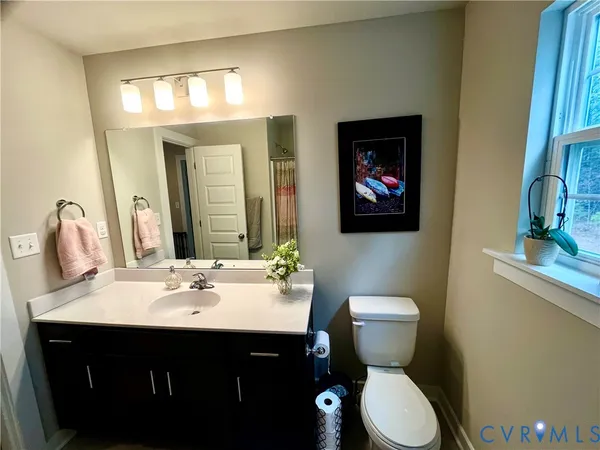 a bathroom with a sink vanity granite tub and shower