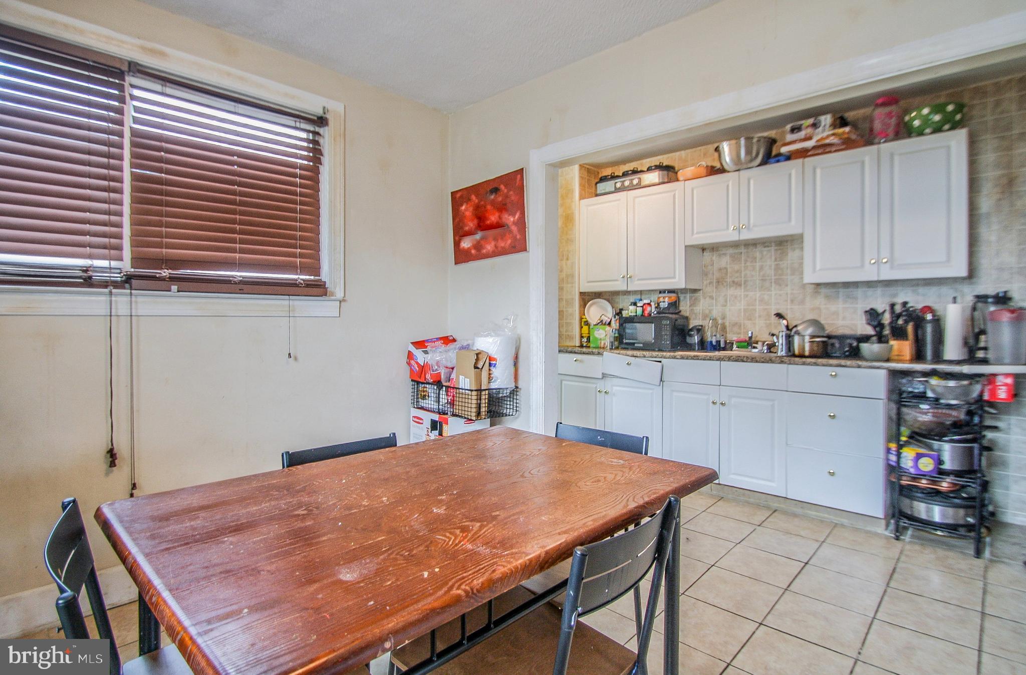 246 Coverly Road Lansdowne, PA 19050 - Photo 14 of 31 a kitchen with a table chairs sink and cabinets