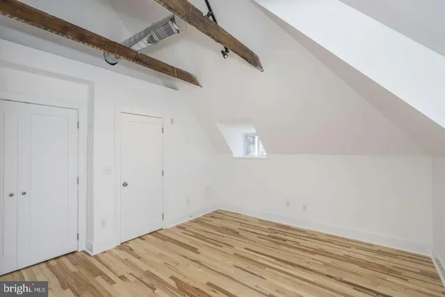 a view of a room with wooden floor and white walls