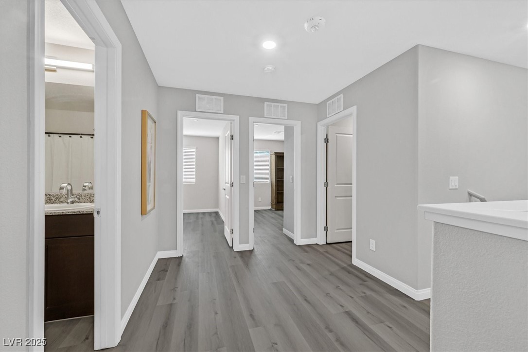 12264 Radiant Sunrise Road, Unit 3 Las Vegas, NV 89183 - Photo 15 of 35 Hallway to Primary, bedrooms, laundry, and bathroom