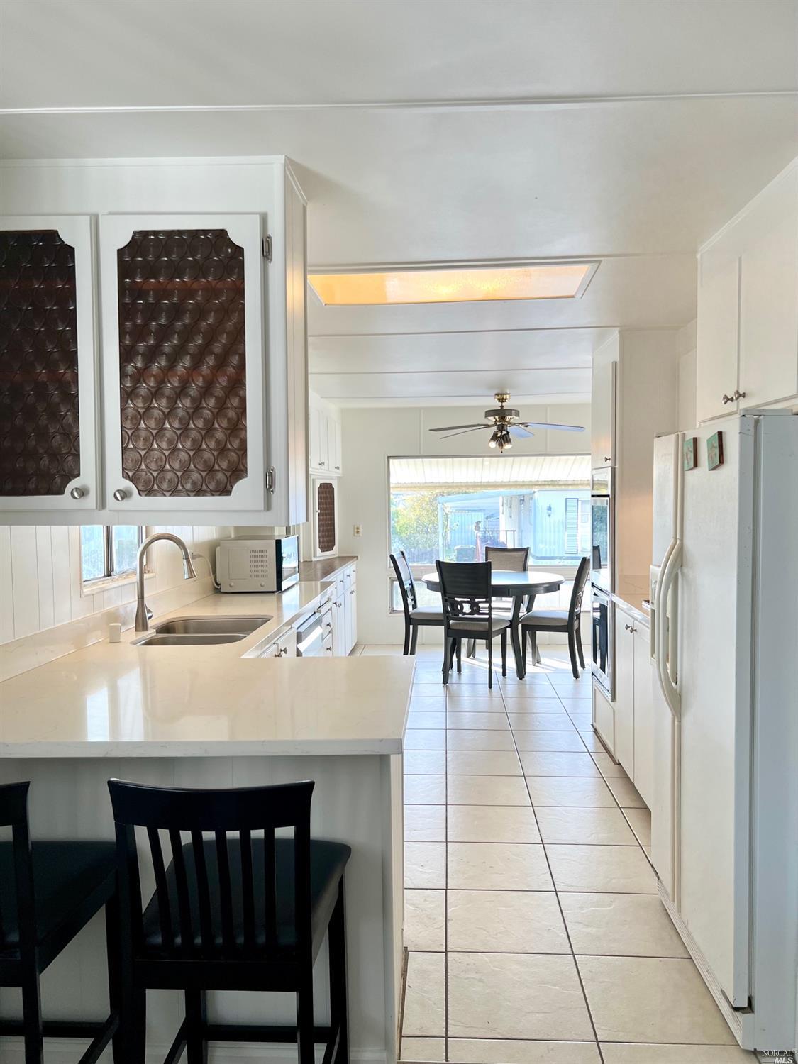 a dining table with chairs and window