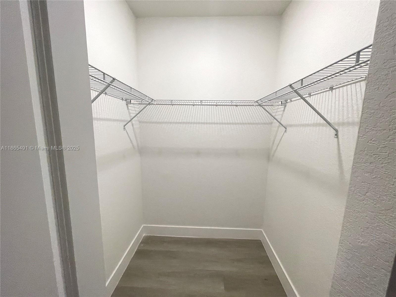 23269 Southwest 129th Path, Unit 23269 Miami, FL 33186 - Photo 13 of 20 a view of a room with racks on the wall