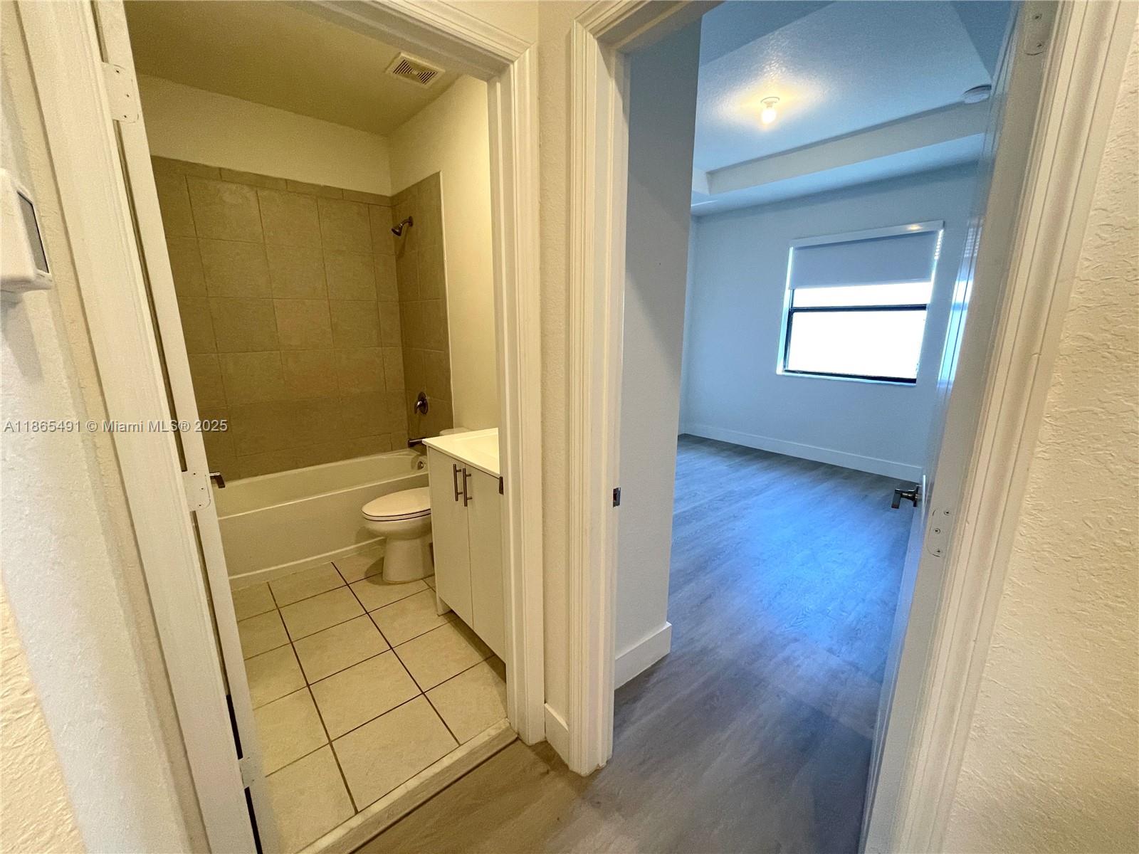 23269 Southwest 129th Path, Unit 23269 Miami, FL 33186 - Photo 19 of 20 a bathroom with a sink and a toilet