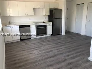 a kitchen with stainless steel appliances granite countertop a refrigerator stove and a sink