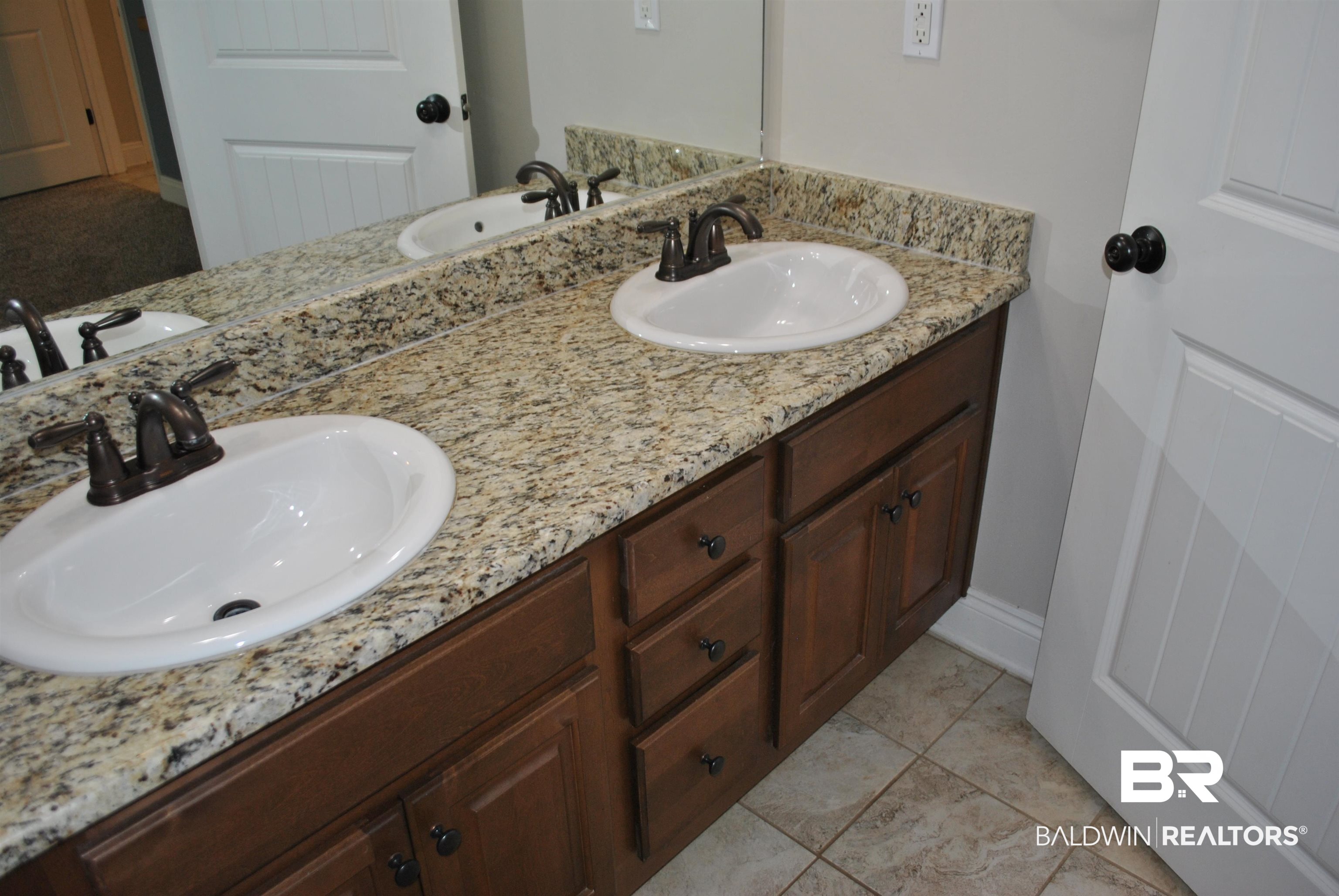 2161 Spring Grove West Mobile, AL 36695 - Photo 20 of 31 Full bathroom featuring double vanity and baseboards