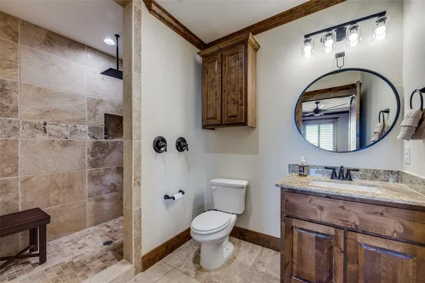 a bathroom with a toilet a sink and mirror