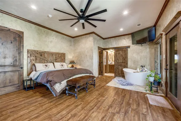 a spacious bedroom with a bed and a chandelier